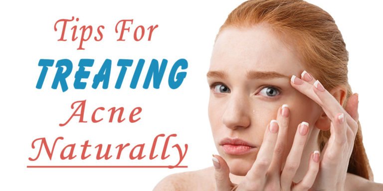 red headed female looks at acne in mirror