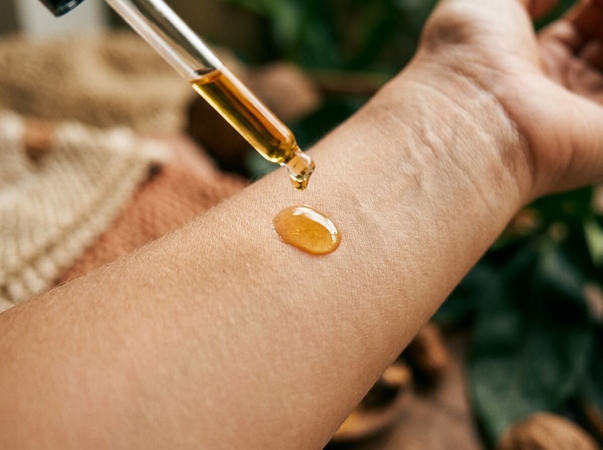 natural face oil drop from glass pipette