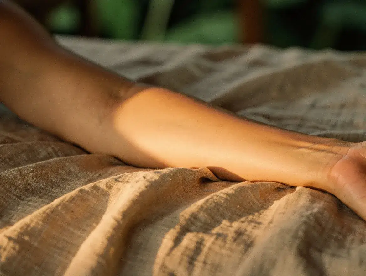 sun-warmed skin resting on linen in warm evening light