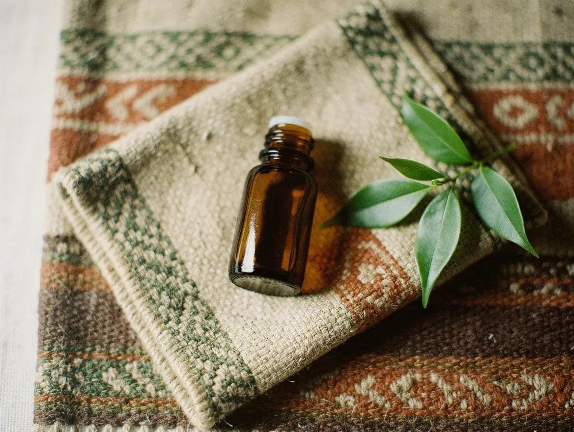 cajeput essential oil bottle on a woven Balinese textile